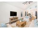 Inviting living room with vaulted ceilings, wood floors, and rustic furniture and decor at 7309 N Huntley Ave, Tampa, FL 33604