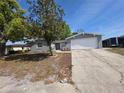 Well-maintained single-story home with a one car garage, concrete driveway, and landscaped front yard at 7740 Sagebrush Dr, Port Richey, FL 34668