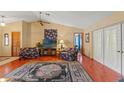 Cozy living room with vaulted ceilings, hardwood floors, a ceiling fan, and comfortable seating at 8195 Wooden Dr, Spring Hill, FL 34606