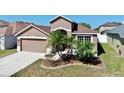 Charming single-story home with landscaped front yard and attached two-car garage at 8603 Sandy Plains Dr, Riverview, FL 33578