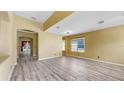 Spacious living room features wood-look floors and lots of natural light at 8603 Sandy Plains Dr, Riverview, FL 33578