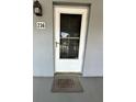 A welcoming front door with a screen door and a 'welcome' mat on a covered porch at 8651 10Th N St # 236, St Petersburg, FL 33702