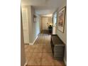 An inviting hallway with tile flooring, storage cabinets, and a view of the front door at 8651 10Th N St # 236, St Petersburg, FL 33702