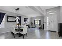 Spacious dining area featuring modern light fixtures, contemporary decor and large window at 10007 Coldwater Loop, Land O Lakes, FL 34638