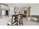 Open-concept kitchen featuring a long countertop and seamlessly flowing into the dining area at 10816 Wendover Dr, Palmetto, FL 34221