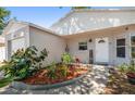 Close up of a home's entrance displaying a welcoming garden with decorative plants at 1108 16Th Nw Ave, Clearwater, FL 33756