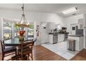 Bright kitchen featuring white cabinetry, stainless steel appliances, and an adjacent dining area at 1108 16Th Nw Ave, Clearwater, FL 33756