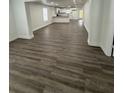 Spacious living room featuring modern flooring and an open layout with easy access to the kitchen at 112 N Betty Ln, Clearwater, FL 33755