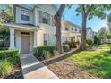 Charming townhouse featuring a well-kept lawn and inviting front entrance at 13777 Forest Lake Dr, Largo, FL 33771
