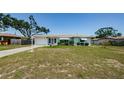 Expansive lawn complements this inviting single-story home, promising ample outdoor space at 1524 Lemon St, Clearwater, FL 33756