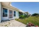 Inviting entrance showcases beautiful plants and flowers, adding charm to this lovely home at 1524 Lemon St, Clearwater, FL 33756
