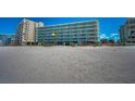 Beachside condo building featuring a light blue exterior with balconies and a stunning oceanfront location at 19440 Gulf Blvd # 306, Indian Shores, FL 33785