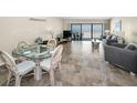 Bright living space featuring coastal-inspired decor, tile flooring, and ocean views at 19440 Gulf Blvd # 306, Indian Shores, FL 33785