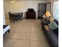 Cozy living area with tile floors and comfortable seating arrangement at 2050 58Th N Ave # 6, St Petersburg, FL 33714