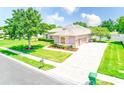 Single-Gathering home with an extended driveway and three-car garage in a manicured community at 2250 Mountain Ash Way, New Port Richey, FL 34655