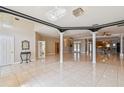 Bright and airy living room boasts tiled floors, elegant columns, and an open floor plan for versatile living at 284 Peninsula Ave, Tarpon Springs, FL 34689