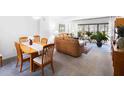 Open-concept living and dining area with a glimpse of the cozy living room and the four-chair dining set at 2900 Cove Cay Dr # 1B, Clearwater, FL 33760
