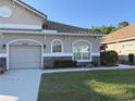 Charming home exterior with a well-maintained lawn, stone accents, and decorative landscaping at 29823 Ganga Way, Wesley Chapel, FL 33543