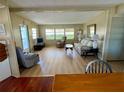 Cozy living room featuring wood floors, bright windows, and comfortable seating arrangements at 34461 Cactus Dr, Pinellas Park, FL 33781