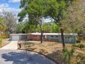 Lovely single-story home with a brick accent, mature trees and driveway with attached garage at 422 Dunedin Cir, Temple Terrace, FL 33617