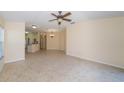 Spacious open-concept living room featuring tile floors and neutral paint at 4235 Angelica Loop, Wesley Chapel, FL 33543