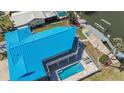 Aerial view showcases a home with a pool, deck, and access to waterfront and boat dock at 4275 Bellaire Dr, Hernando Beach, FL 34607