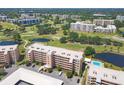 Lovely aerial view showcasing a residential building near a golf course, pools and natural ponds at 4550 Pinebrook Cir # 505, Bradenton, FL 34209