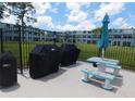 Outdoor picnic area with table, benches, grills and a shade umbrella for community gatherings at 4715 Bay Ne St # 119, St Petersburg, FL 33703