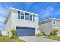 Charming home with a blue two-car garage, complemented by manicured landscaping and a bright, welcoming exterior at 636 Sunlit Coral St, Ruskin, FL 33570