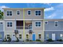 Two-story exterior features a mix of brick and neutral siding, complemented by inviting blue door at 718 S 22Nd St, Tampa, FL 33605
