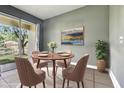 Cozy dining room with large windows offering peaceful views, perfect for gatherings at 8125 Stone Path Way, Tampa, FL 33647