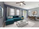 Bright living room with ample seating, ceiling fan, and sliding glass doors at 8125 Stone Path Way, Tampa, FL 33647