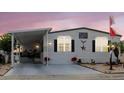 Charming home with a covered carport, flag, and patriotic decor in a desirable community at 8444 Fantasia Park Way, Riverview, FL 33578
