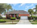 Charming, single-story home with a well-manicured lawn, and a two car garage at 8827 Helmsly Ln, Hudson, FL 34667
