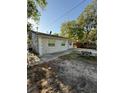 View of the side of the house with a picnic table in the yard at 9618 N 13Th St, Tampa, FL 33612