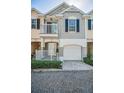 Attractive townhome with a private garage, balcony, and well-maintained front entrance at 985 Wellington Ct, Dunedin, FL 34698
