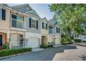 Charming townhomes each with a single car garage, front porch and second story balcony at 985 Wellington Ct, Dunedin, FL 34698