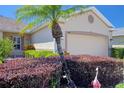 Well-maintained single-story home with neatly trimmed bushes, tropical plants and inviting curb appeal at 1023 Orca Ct, Holiday, FL 34691