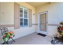 Inviting front porch featuring a comfortable seating area and a secure front door with a screen at 1023 Orca Ct, Holiday, FL 34691