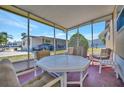 Relaxing screened porch features comfortable seating and beautiful outdoor views at 104 Saint Kitts Way, Apollo Beach, FL 33572
