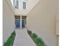 Inviting walkway between units with two front doors, enhanced with charming landscaping at 10947 Verawood Dr, Riverview, FL 33579