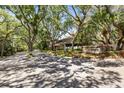 Quiet community street lined with mature trees and lush landscaping in Parkside Colony at 110 Parkside Colony Dr, Tarpon Springs, FL 34689