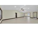 Spacious open-concept living room with recessed lighting and neutral tile flooring at 11797 David Ct, Largo, FL 33778