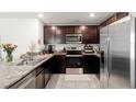 Modern kitchen featuring stainless steel appliances and granite countertops at 12168 Lily Magnolia Ln, Riverview, FL 33569
