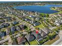 Aerial view of the home showcasing a lake view and the community with lush greenery at 12206 Blue Pacific Dr, Riverview, FL 33579