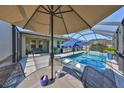 Relaxing outdoor space featuring a screened-in pool, patio seating, and a built-in grill at 12206 Blue Pacific Dr, Riverview, FL 33579