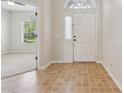 Inviting entryway with tile flooring, a front door, and a glimpse into the adjacent living space at 13812 Sigler St, Riverview, FL 33579