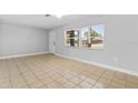 Bright living room featuring neutral paint, tile flooring, and large windows allowing natural light at 170 Argus Rd, Venice, FL 34293
