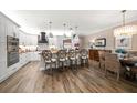 Bright, open kitchen featuring white cabinets, a black range hood, pendant lights, and island seating for four at 19817 Gulf Blvd # 602, Indian Shores, FL 33785