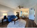 Nicely decorated living room featuring neutral walls, a blue sofa, and a dining area with decorative chandelier at 2253 Norwegian Dr # 63, Clearwater, FL 33763